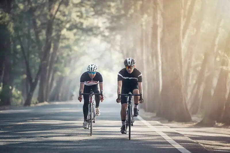 two cyclists riding