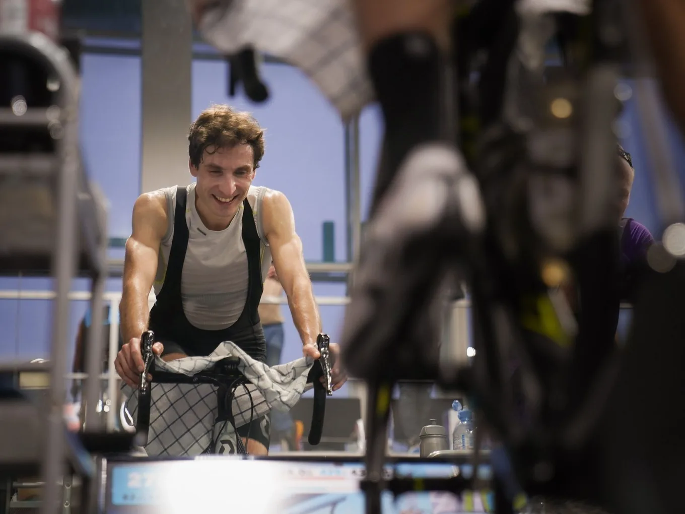 Cyclist training hard indoors on a road bike mounted to a turbo trainer
