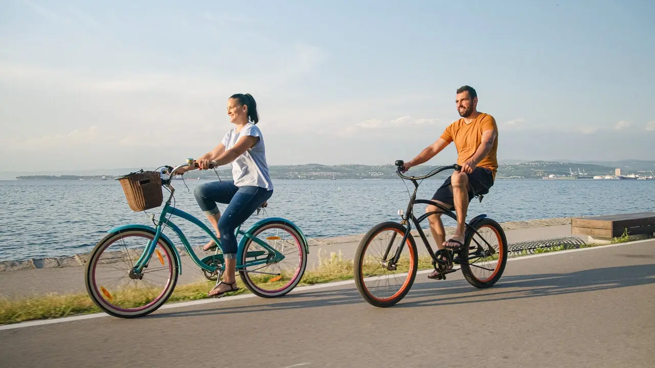 couple cycling by a beach couple cycling by a beach