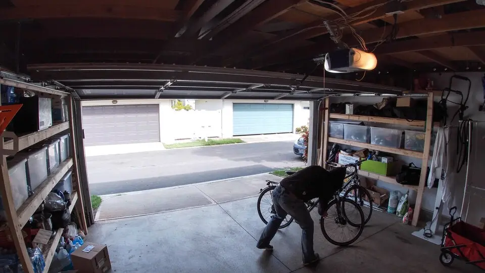 Several bicycles stored together in a home garage