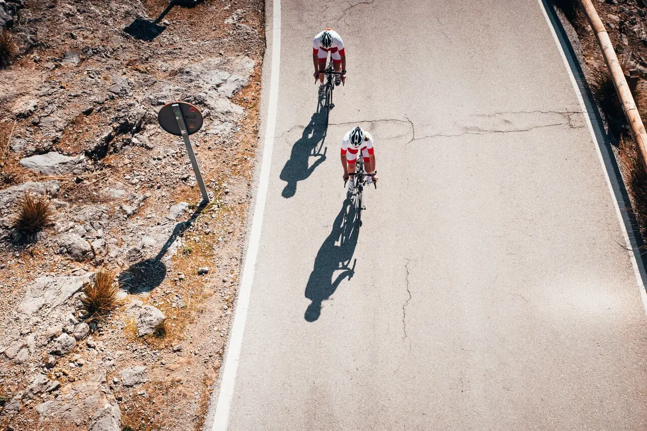 two cyclists training together two cyclists training together