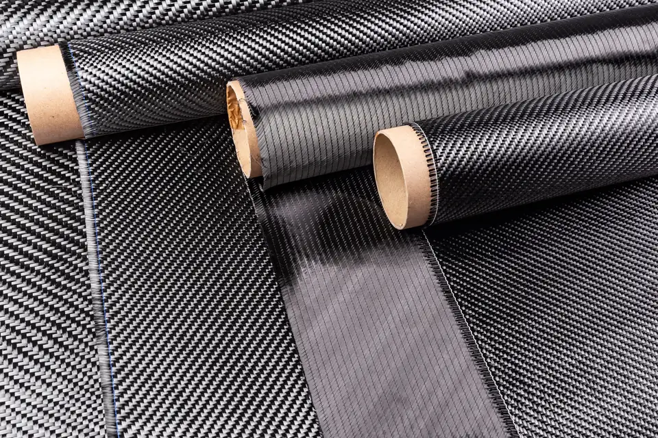 Rolls of woven carbon fiber cloth Rolls of raw woven carbon fiber cloth showing the diagonal twill weave of the carbon strands