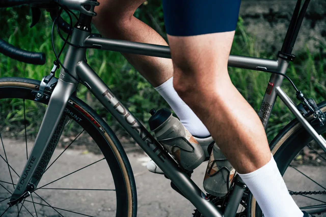 Gear down early and keep the legs turning Close-up of a road cyclist's legs mid pedal stroke