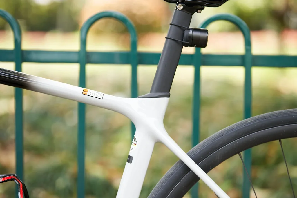 Close-up of a carbon road bike frame at the seatpost clamp, seat cluster, and seatstays