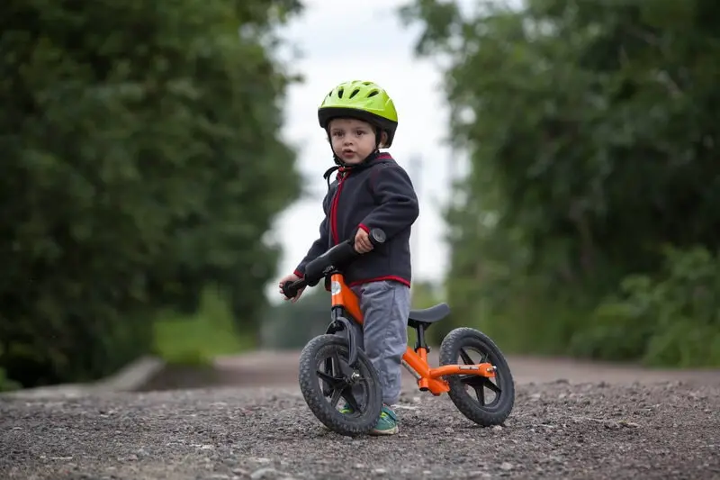 kid on a balance bike kid on a balance bike