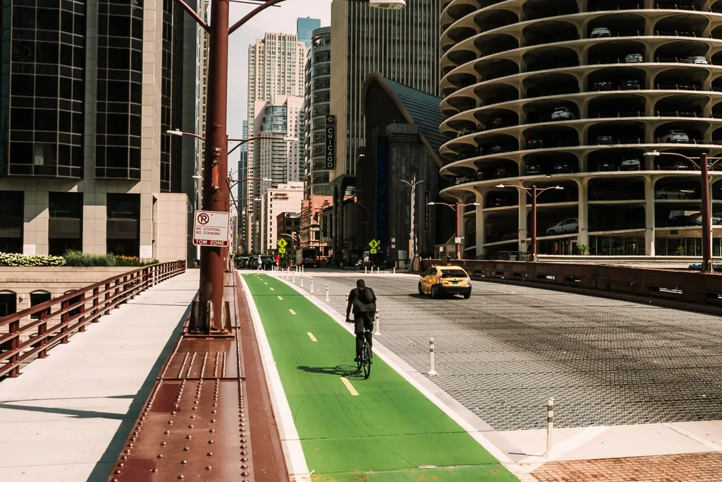 Commuter in a protected Chicago bike lane Commuter riding in a protected green bike lane across a Chicago River bridge in downtown Chicago