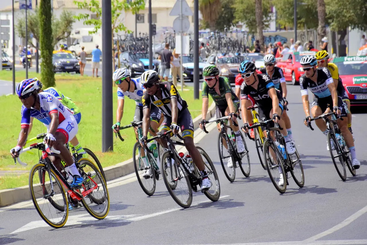 Every peptide in this article is prohibited in and out of competition for licensed racers Road racers leaning through a corner in a tight pack during a road race