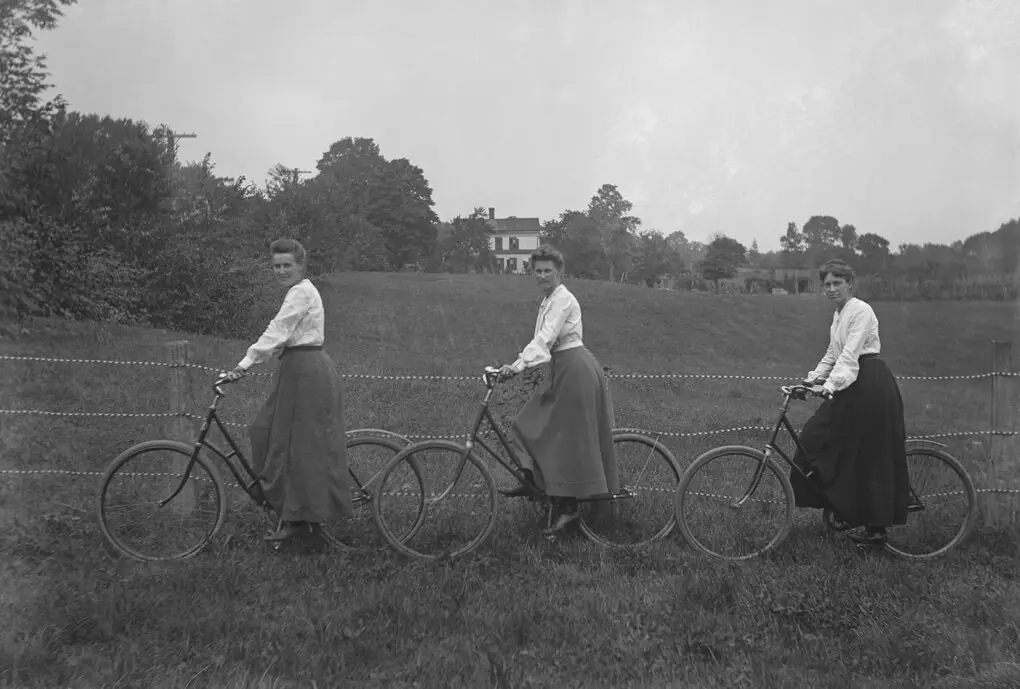 women cyclists in a field