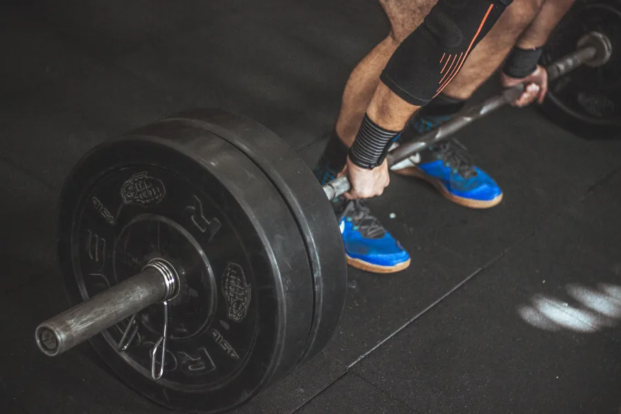 Heavy, brief, and consistent - the off-season is when you build the base Close-up of a lifter gripping a loaded barbell for a deadlift