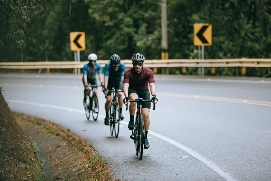 Economy gains carry straight over to how a long ride feels Three road cyclists riding in a paceline on a forest road