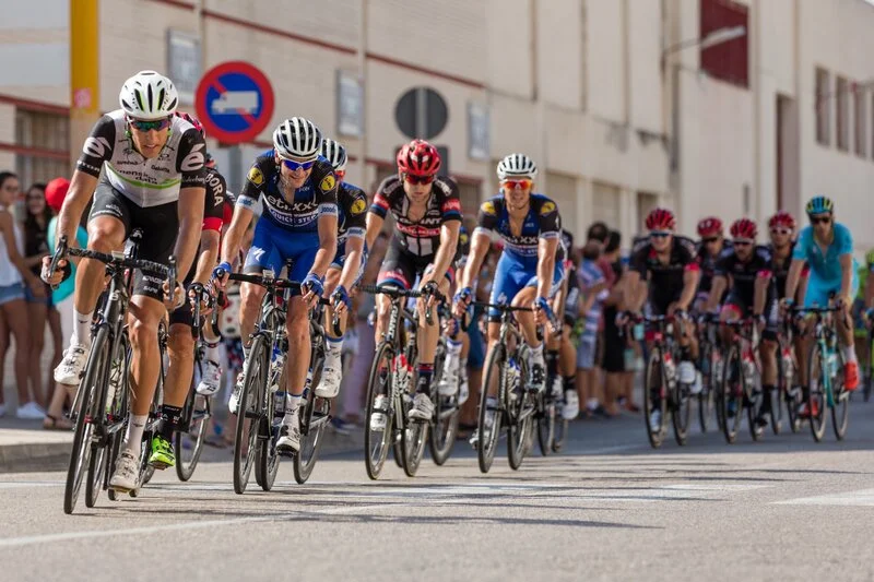 Road cyclists racing in a peloton